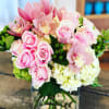 The perfect combination of pinks, greens and whites.  Roses and cymbidium