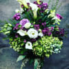A gorgeous array of lavender, green and white blooms designed in a