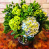 Just a big, fat vase full of green and blue hydrangea with