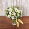 This adorable floral arrangement comes in a mason jar filled with daisies