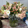 This arrangement has white lizzy, pink hypericum, peach stock and alstroemeria.
