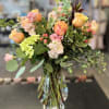 This arrangement has roses, hypericum berries, stock, hydrangea and more.