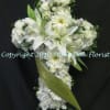 Serene arrangement of White Lilies, Roses, Hydrangeas, Gerber Daisies, and other flowers.