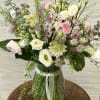 This delicate arrangement includes ranunculus, scabiosa, astrantia and lisianthus.