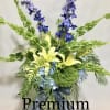 This arrangement contains delphinium, green accent flowers, hydrangea, blue iris, and other