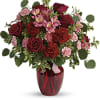The belle of the ball! Arranged in a ruby red vase, this