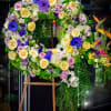 Sympathy wreath arranged with spring flowers.  Standard size 24 inches