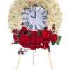 This elegant and meaningful floral clock arrangement symbolizes the passage of time
