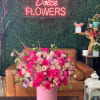 Beautiful mix of pink seasonal roses and flowers arranged in a white