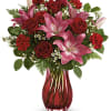 Elegantly swirling glass, radiant red roses and pretty pink lilies are sure