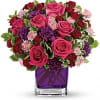Pure romance. Hot pink roses and dark red spray roses are brightly
