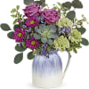 Pitcher perfect! Finished with an iridescent glaze, this food-safe ceramic pitcher lends