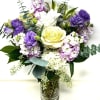 Lovely soft blooms of lavender pink and white. Arranged in a traditional