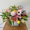 A pretty seasonal arrangement in a 5inch glass cube with alstroemerias, yellow