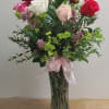 A beautiful arrangement of one dozen assorted color roses. The pops of
