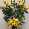 Yellow roses hand arranged in a vase by our designers with filler