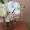 A clean, simple but elegant compact arrangement in a peach clear vase.