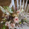 A combination of soft toned fresh flowers and neutral dried flowers that
