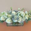Long and low centerpiece in a clear rectangular vase. Perfect for any