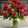 One dozen red roses, baby&#039;s breath and greenery in a vase