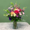 A charming mixed arrangement that showcases vibrant colors. Featuring roses, carnations, garden