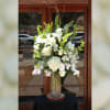 This elegant white arrangement is filled with our finest white flowers.