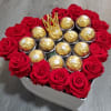 A Heart Box filled with chocolate and fresh roses accented with a
