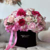 This charming arrangement of flowers combines the softness of pink with the