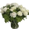 A full upscale arrangement of filled with lush white  roses and