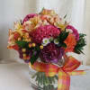 Nosegay of roses, berries, asters, carnations, alstroemeria, and other flowers.