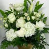 Elegant and timeless all-white flowers in a complementary compote bowl, sure to