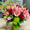 A lovely bouquet is filled with hydrangeas, snapdragons, roses, spray roses, hypericum