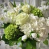 Stunning style is captured with a compact design of all white flowers