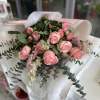 A bouquet of 6 pink roses and mini roses and other seasonal