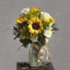 A cheerful mason jar arrangement of yellow sunflowers, white daisies, and white