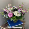 Consisting of various hues of purple and white florals like roses, snapdragon
