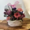 Arylic box with roses carnations statice and tulips