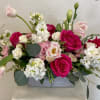 Roses tulips stock and lisianthus in a ceramic vase