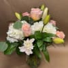 A Beautiful arrangement filled with white hydrangeas, pink roses, and white lilies!