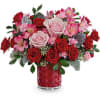 Adorned with a charming heart pattern, this delightful red glass vase adds