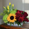 A stunning arrangement featuring a sunflower and roses that captures the essence