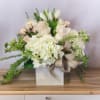 This sophisticated arrangement features an elegant mix of white and cream blooms