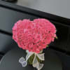 The product contains pink multi-headed roses, shaped with flower mud. 