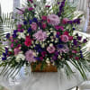 Shades of purple roses, stock, larkspur, cremons, status, and filler flowers.