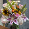 Blushing sun is a vibrant and elegant arrangement featuring radiant sunflowers 