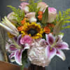 Blushing sun is a vibrant and elegant arrangement featuring radiant sunflowers 
