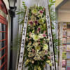 Pink and White flowers in a standing spray.