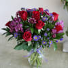 Red roses, purple monte casino, poms and alstroemeria. 