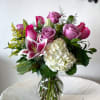 A mix of purple and pink roses, pop of stargazer and hydrangea