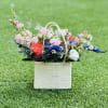 Beautiful blooms in a cute basket hand made by Honduran artisans, this